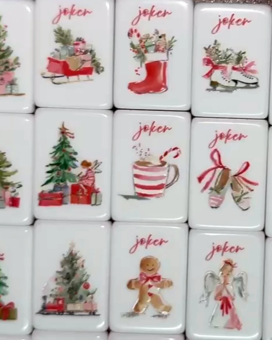 Noel Collection joker tiles: a sleigh of presents, a stocking, ice skates, cocoa with a candy cane, ballet slippers, a gingerbread man and an angel, each lettered &ldquo;joker.&rdquo;